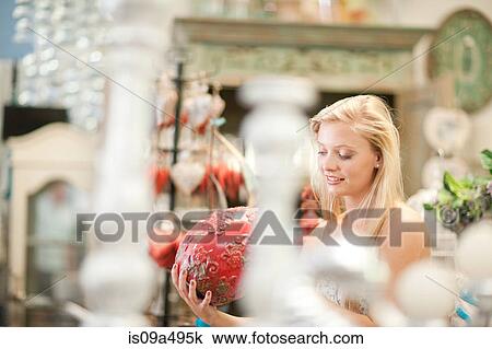Smiling woman shopping in store View Large Photo Image Stock Image - Smiling woman shopping in store. Fotosearch