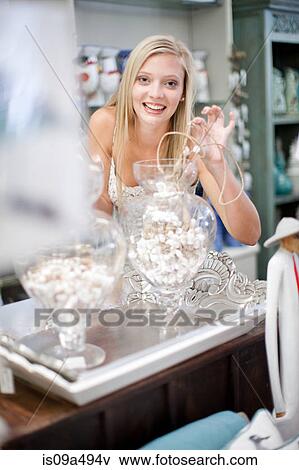 Stock Photo - Smiling woman shopping in store. Fotosearch