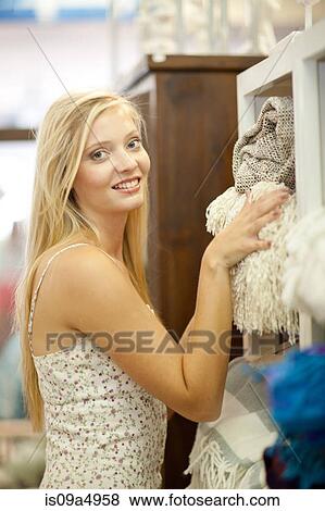 Smiling woman shopping in store View Large Photo Image Stock Photo - Smiling woman shopping in store. Fotosearch