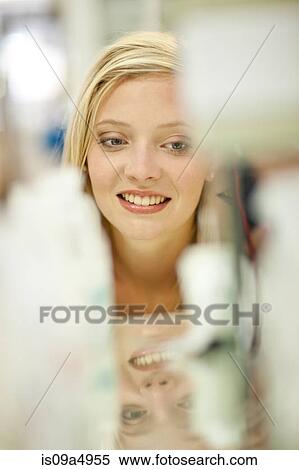 Smiling woman shopping in store View Large Photo Image Stock Photography - Smiling woman shopping in store. Fotosearch