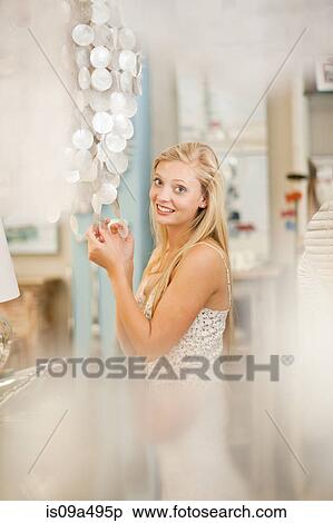 Smiling woman shopping in store View Large Photo Image Stock Photography - Smiling woman shopping in store. Fotosearch