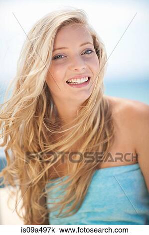Smiling woman sitting outdoors View Large Photo Image Stock Image - Smiling woman sitting outdoors. Fotosearch