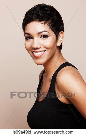 Smiling woman standing indoors View Large Photo Image Stock Image - Smiling woman standing indoors. Fotosearch