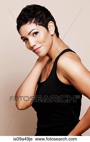 Smiling woman standing indoors View Large Photo Image Stock Image - Smiling woman standing indoors. Fotosearch