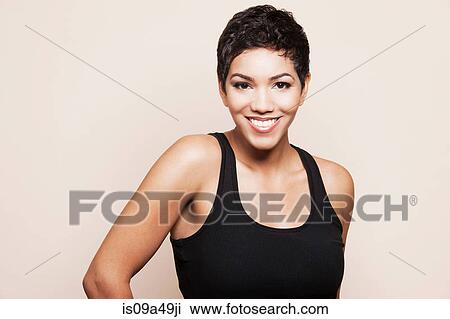 Smiling woman standing indoors View Large Photo Image Stock Image - Smiling woman standing indoors. Fotosearch