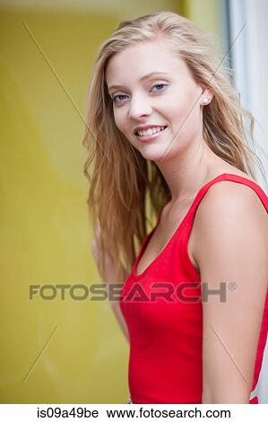 Stock Image - Smiling woman standing outdoors. Fotosearch