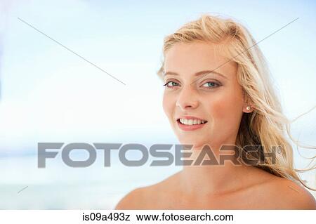 Stock Photo - Smiling woman standing outdoors. Fotosearch