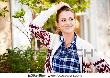 Smiling woman standing outdoors View Large Photo Image Stock Photo - Smiling woman standing outdoors. Fotosearch