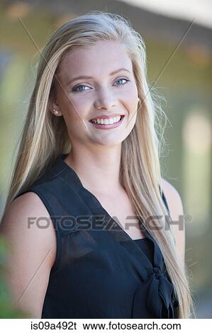 Stock Photograph - Smiling woman standing outdoors. Fotosearch