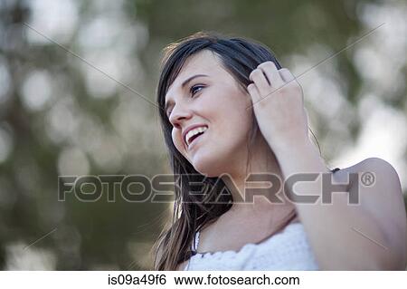 Stock Photograph - Smiling woman standing outdoors. Fotosearch