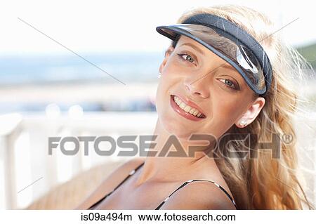 Smiling woman sunbathing outdoors View Large Photo Image Picture - Smiling woman sunbathing outdoors. Fotosearch