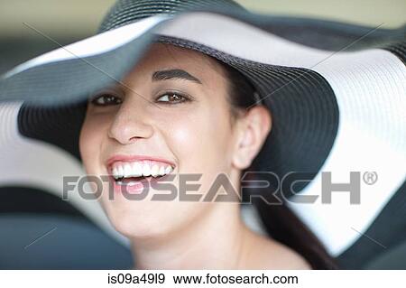 Stock Photo - Smiling woman wearing sun hat. Fotosearch