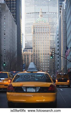 Taxis driving on city street View Large Photo Image Stock Photo - Taxis driving on city street. Fotosearch