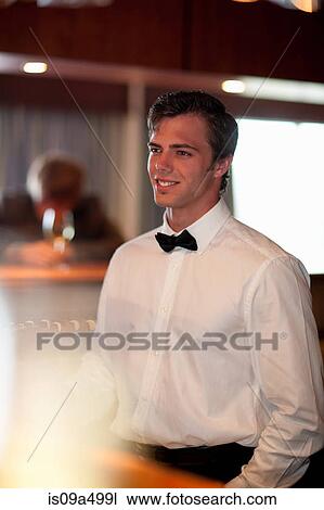 Waiter standing behind restaurant bar View Large Photo Image Stock Image - Waiter standing behind restaurant bar. Fotosearch