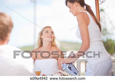 Waitress serving woman coffee at table View Large Photo Image Stock Image - Waitress serving woman coffee at table. Fotosearch