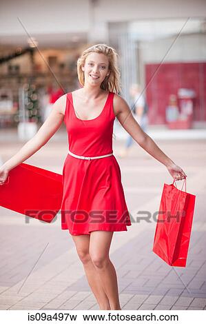 Woman carrying shopping bags in mall View Large Photo Image Stock Photo - Woman carrying shopping bags in mall. Fotosearch