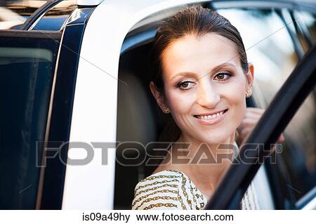 Woman climbing out of car View Large Photo Image Stock Photo - Woman climbing out of car. Fotosearch