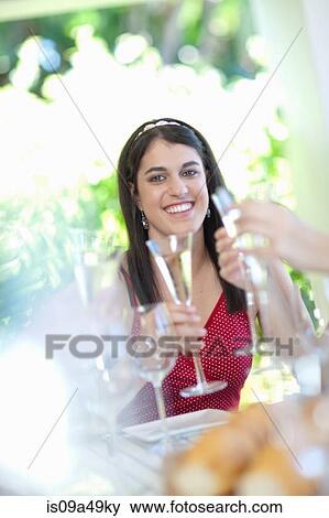 Woman drinking champagne at table View Large Photo Image Stock Photo - Woman drinking champagne at table. Fotosearch