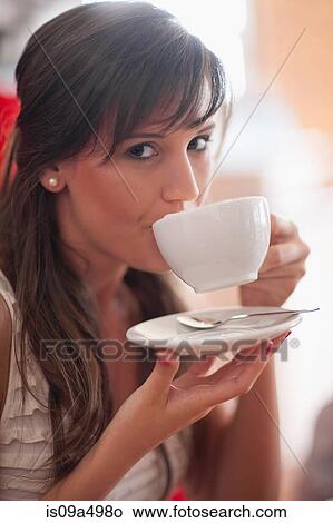 Woman drinking coffee in cafe View Large Photo Image Picture - Woman drinking coffee in cafe. Fotosearch