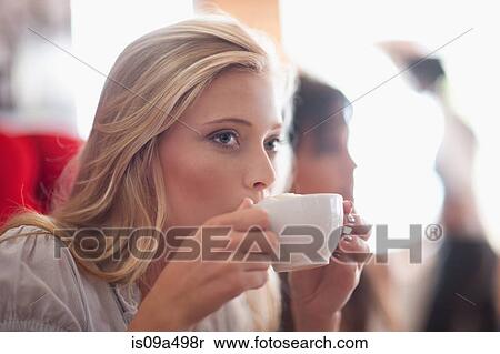 Stock Photography - Woman drinking coffee in cafe. Fotosearch