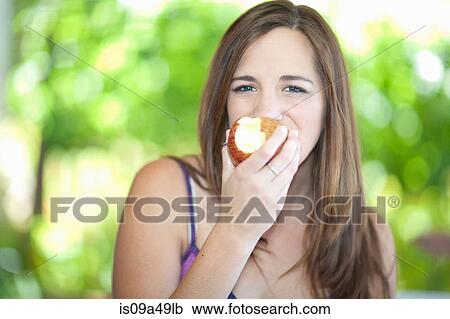 Woman eating apple outdoors View Large Photo Image Stock Image - Woman eating apple outdoors. Fotosearch