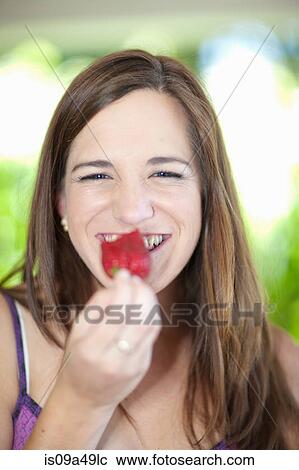 Woman eating fruit outdoors View Large Photo Image Stock Image - Woman eating fruit outdoors. Fotosearch