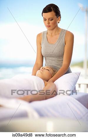 Stock Photo - Woman giving massage outdoors. Fotosearch