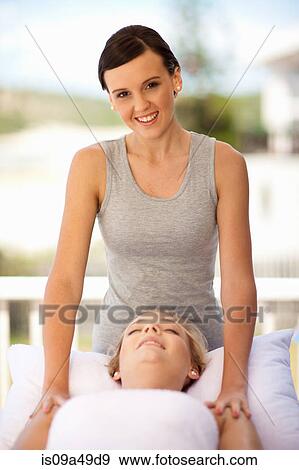 Stock Photo - Woman giving massage outdoors. Fotosearch