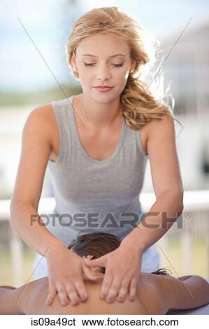 Woman giving massage outdoors View Large Photo Image Stock Photograph - Woman giving massage outdoors. Fotosearch