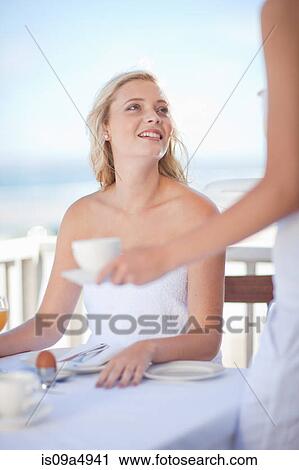 Woman having breakfast outdoors View Large Photo Image Stock Image - Woman having breakfast outdoors. Fotosearch
