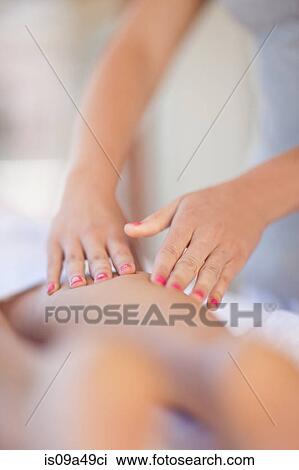 Stock Image - Woman having leg massage. Fotosearch