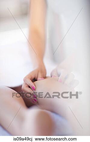 Stock Image - Woman having leg massage. Fotosearch