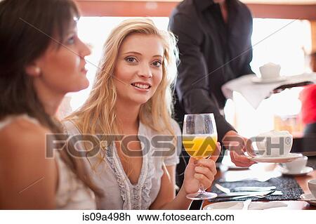 Woman having orange juice in cafe View Large Photo Image Stock Image - Woman having orange juice in cafe. Fotosearch