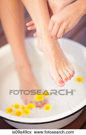 Woman having salt scrub on feet View Large Photo Image Stock Photo - Woman having salt scrub on feet. Fotosearch