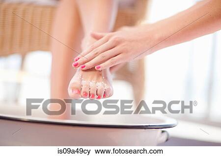 Woman having salt scrub on feet View Large Photo Image Stock Photo - Woman having salt scrub on feet. Fotosearch