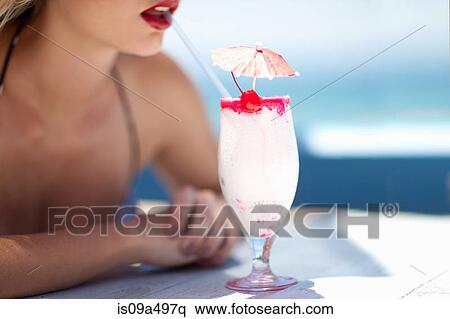 Woman having tropical drink outdoors View Large Photo Image Stock Photography - Woman having tropical drink outdoors. Fotosearch