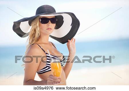 Woman in bikini and floppy hat on beach View Large Photo Image Stock Photograph - Woman in bikini and floppy hat on beach. Fotosearch