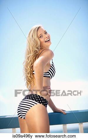 Woman in bikini standing on deck View Large Photo Image Stock Photo - Woman in bikini standing on deck. Fotosearch