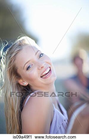 Stock Image - Woman laughing outdoors. Fotosearch