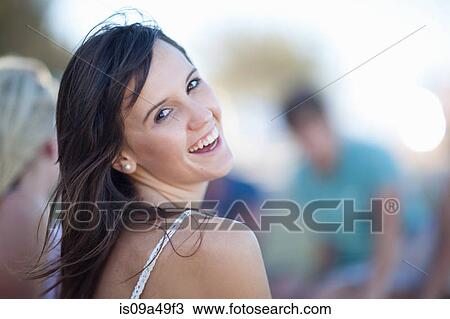 Stock Image - Woman laughing outdoors. Fotosearch