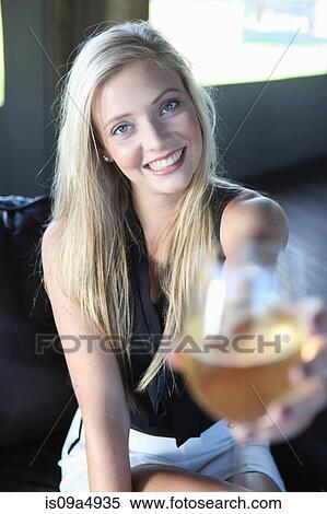 Stock Photography - Woman offering glass of wine. Fotosearch