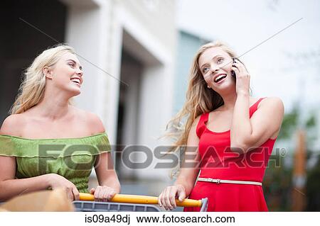 Stock Image - Woman on cell phone and shopping. Fotosearch