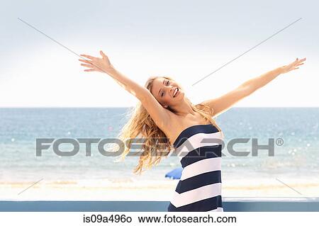 Picture - Woman playing on beach. Fotosearch