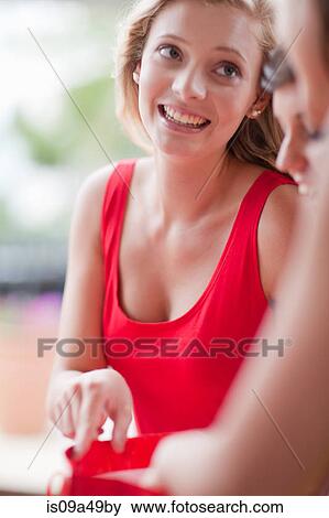 Stock Photo - Woman pointing in shopping bag. Fotosearch