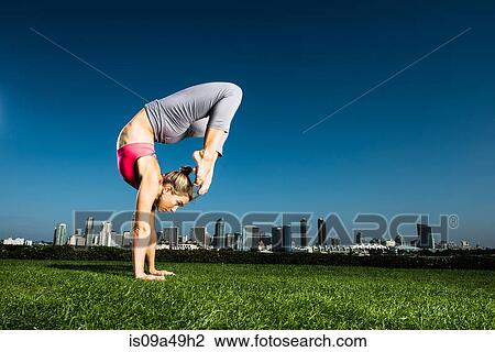 Woman practicing yoga in urban park View Large Photo Image Stock Image - Woman practicing yoga in urban park. Fotosearch
