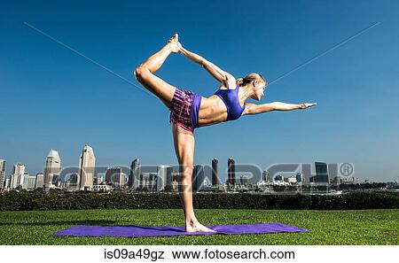Woman practicing yoga in urban park View Large Photo Image Stock Photo - Woman practicing yoga in urban park. Fotosearch