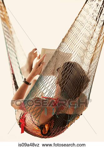 Woman reading book in hammock View Large Photo Image Stock Photo - Woman reading book in hammock. Fotosearch