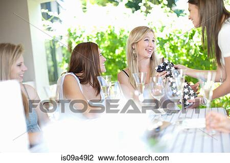 Woman receiving presents at party View Large Photo Image Stock Image - Woman receiving presents at party. Fotosearch
