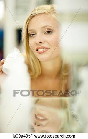 Stock Image - Woman shopping in store. Fotosearch