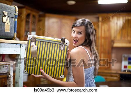 Stock Image - Woman shopping in thrift store. Fotosearch